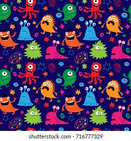 Seamless pattern with a cute aliens on a blue background