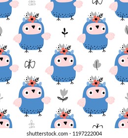 Seamless pattern of cute blue owls with flowers in on a white background. Vector illustration for kids.
