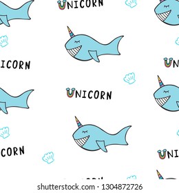Seamless pattern with cute blue whales with words unicorn. Vector baby shower background. Hand drawn vector illustration.