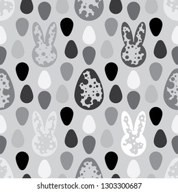 Seamless pattern of cute bunnies and eggs. Minimalistic monochromatic dotted textile design. Vector drawing repeat pattern of Easter rabbits and eggs. Endless wallpaper print. 