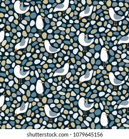 Seamless pattern with cute cartoon seagulls and pebbles. Vector wallpaper. Good for print.