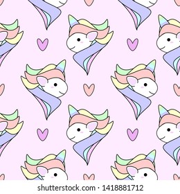 seamless pattern with cute cartoon unicorn face and hearts design on pink background 