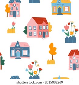 Seamless pattern with cute colored bright houses, flowers and trees on a white background. Trendy modern texture for textile,  fabric, wallpaper.