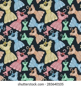 Seamless pattern. Cute colorful dresses on hangers for clothes with bows. Dark background. Drawing by hand. Vector graphics.