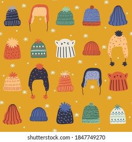 Seamless pattern of cute cozy winter knit hats and caps.  Hand drawn vector colorful funny cartoon style illustration. 