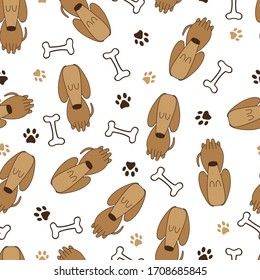 Seamless  pattern of cute dogs, footprints and bones. Vector illustration on a white background. 