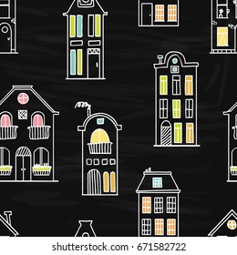 Seamless pattern with cute doodle houses  on black chalkboard background. Outline drawing with colorful splashes