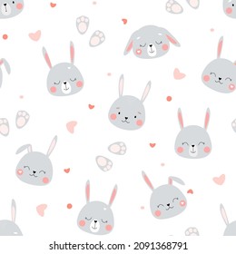 Seamless pattern with cute funny bunnies. The head of rabbits with hearts on a white background. Children's ornament for textiles, fabrics. Vector graphics.