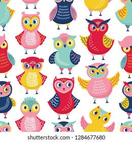 Seamless pattern with cute funny owls or owlets on white background. Childish backdrop with intelligent forest birds. Flat cartoon vector illustration for wrapping paper, wallpaper, textile print.