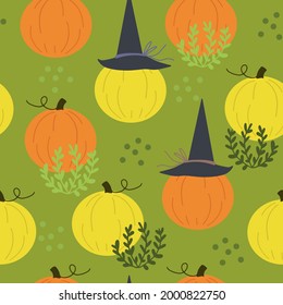 Seamless pattern with cute halloween pumpkins in witches hats on a field like background