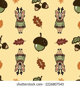 A seamless pattern with a cute hand-drawn deer character, oak leaves and acorns, an autumn season background with a doodle deer wearing a sweater