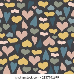 Seamless pattern of cute hearts of pastel colors on a dark background. Wallpaper for season decoration, wrapping paper, clothing prints. Vector illustration.