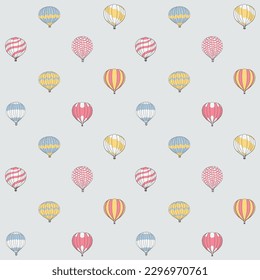Seamless pattern of cute hot air balloons in multicolors and patterns against a blue sky. Great for nurseries, children's clothes, stationery, bedspreads and more.