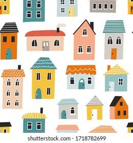 Seamless pattern with cute houses. Hand drawn vector illustration for nursery textile or wallpaper design.