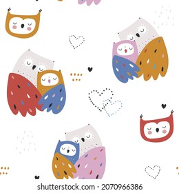 Seamless pattern with cute mom and baby owls. Childish owl birds background. Ideal for fabrics, textiles, apparel, wallpaper.