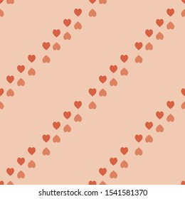 Seamless pattern with cute orange hearts on light orange background. Vector image. 