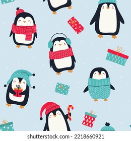 Seamless pattern with cute penguins and gift boxes on blue background. Funny penguins in red Christmas hat, sweater and scarf. Christmas and New Year ornament pattern. For textiles, wrapping paper