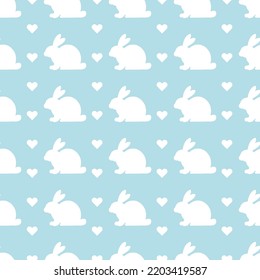 Seamless pattern with cute rabbits and hearts on a light blue background. Symbol of 2023. Vector illustration.