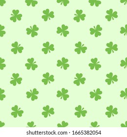 Seamless pattern with cute small three-leaf clover leaves. St. Patrick's day vector illustration with shamrock.