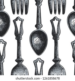 Seamless pattern with cutlery.Sketch of spoons and forks on a white background.Vector vintage illustration.