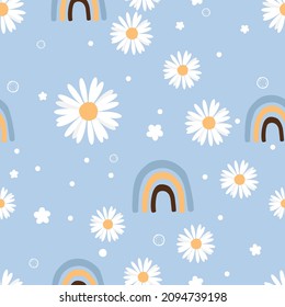 Seamless pattern daisy flower, little stars and rainbows on blue background vector illustration. Cute floral wallpaper.