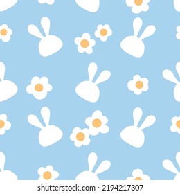 Seamless pattern with daisy flower and rabbit cartoons on blue background vector illustration.