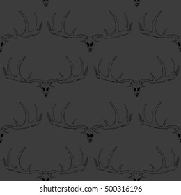 Seamless pattern. Dark antlers and skulls on a gray background. Vector illustration.