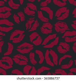 Seamless pattern with dark lipstick kisses. Different imprints of dark red lipstick isolated on a black background. Can be used for design of fabric print, wrapping paper or romantic greeting card