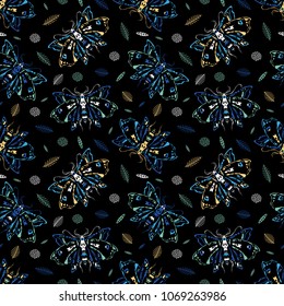 Seamless pattern. Dead head butterfly. Night butterflies among flowers and leaves. Great for print on a T-shirt. Ideal for decoration of Halloween and the Day of the Dead.