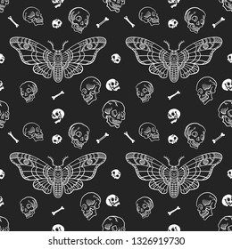 Seamless pattern. Dead head butterfly. Moth among skulls and bones isolated on a black background. Great for tattoo, print on a T-shirt, for decoration of Halloween and more.