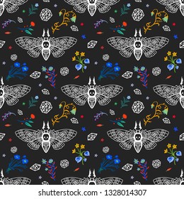 Seamless pattern. Dead head butterfly in night garden. Beautiful wildflowers. Moth among flowers and stones isolated on a black background. Hand drawn illustration for Halloween and more.