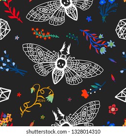 Seamless pattern. Dead head butterfly in night garden. Moth among flowers and stones isolated on a black background. Great for Halloween.