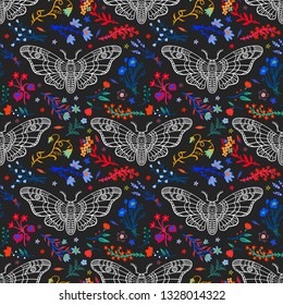 Seamless pattern. Dead head butterfly in night garden. Beautiful wildflowers. Moth among flowers isolated on a black background. Great for Halloween.