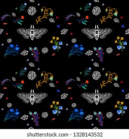 Seamless pattern. Dead head butterfly in night garden. Moth among flowers and stones isolated on a black background. Hand drawn illustration for Halloween and more.