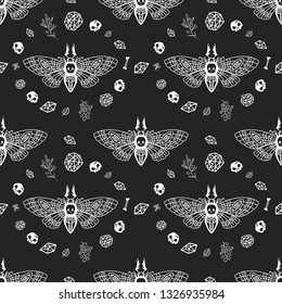 Seamless pattern. Dead head moth among the magical items on a black background. Hand drawn illustration. Great for tattoo, print on a T-shirt, for decoration of Halloween and more.