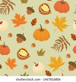 Seamless pattern decorated with floral elements like walnut, acorn, maple leaves, pumpkin, mushrooms and fern. Autumn harvest illustrations that can be used as textile, fabric, wrapping paper print.