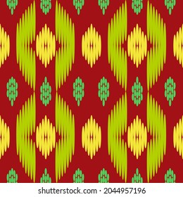 Seamless pattern for decoration, tribal design in yellow and green on red background.