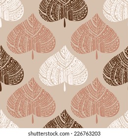 Seamless pattern with decorative autumn leaves. Brown, red and white silhouettes on ocher background.