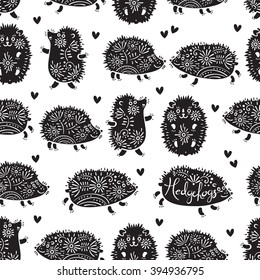 Seamless pattern with decorative hedgehogs. Cute kids background. Vector illustration.
