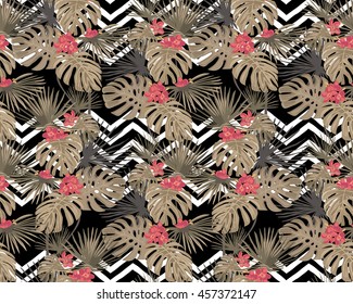 Seamless pattern  with decorative tropical leaves and flowers. White zigzag on a black background.