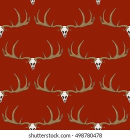 Seamless pattern. Deer antlers and skull on a dark red background. Vector illustration.