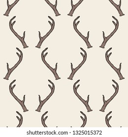 Seamless pattern with deer antlers. Vector hipster trendy background. Nature wildlife animal light brown backdrop.