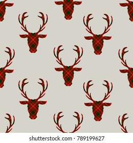 Seamless pattern with deer head on tartan. Vector illustration.