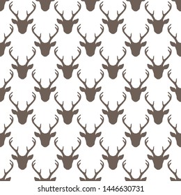 Seamless pattern with deer heads silhouettes. Vector vintage trendy background in brown over white. Nature wildlife animal backdrop.