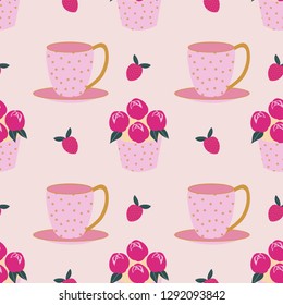 Seamless pattern of delicious flower cupcakes, strawberries, and cute polka dot teacups for an afternoon tea party. Great for textile print, invitations, or packaging. Vector file.