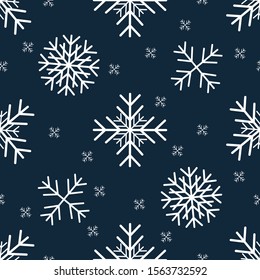 Seamless pattern with different snowflakes on a blue background