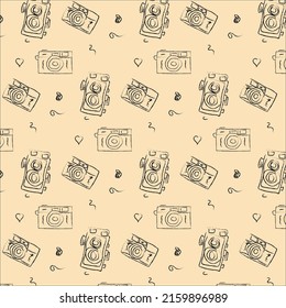 seamless pattern of different vintage cameras drawn by hand on a light background