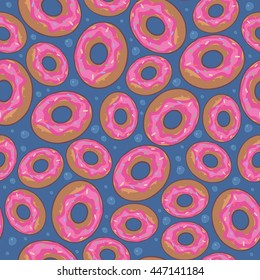 Seamless pattern with donuts and pink glaze on blue background