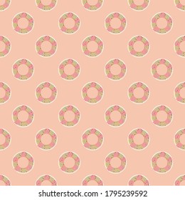 Seamless pattern of donuts topped with pink cream and sugar flakes, placed on a pastel orange background.