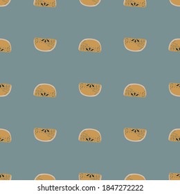 Seamless pattern with doodle apple slices silhouettes ornament. Ocher fruit print on pastel blue background. Graphic design for wrapping paper and fabric textures. Vector Illustration.